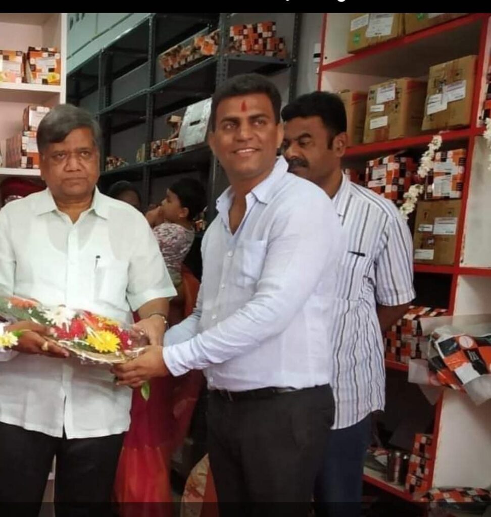 The owner of Mrutyunjaya Automobiles receiving a bouquet at the launch of the Mahindra Genuine Spare Parts retail outlet.
